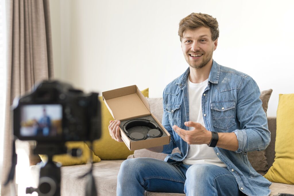 Influencer promoting a headphone packed in a flat cardboard box