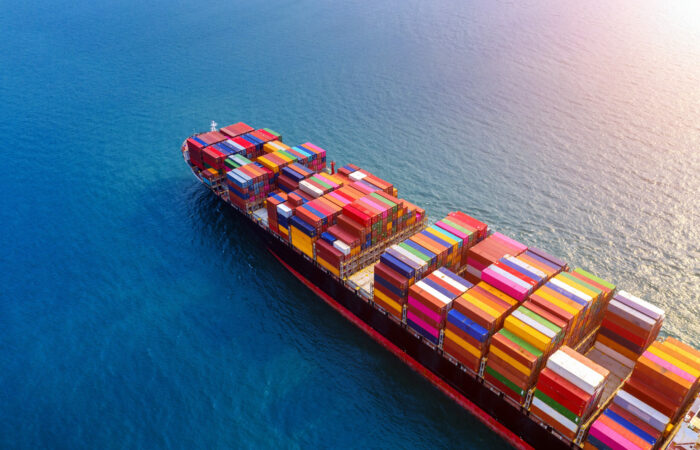 Ship sailing on sea with containers carrying freight boxes